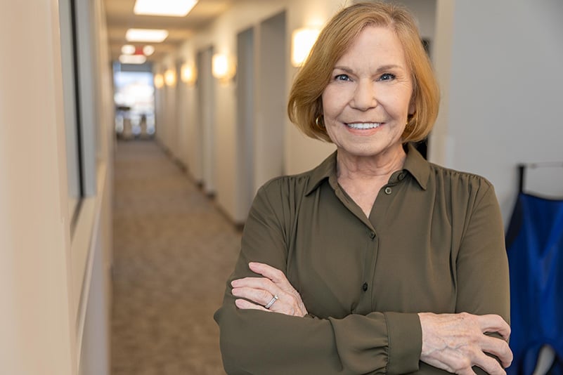 Patient smiling after implant supported dentures