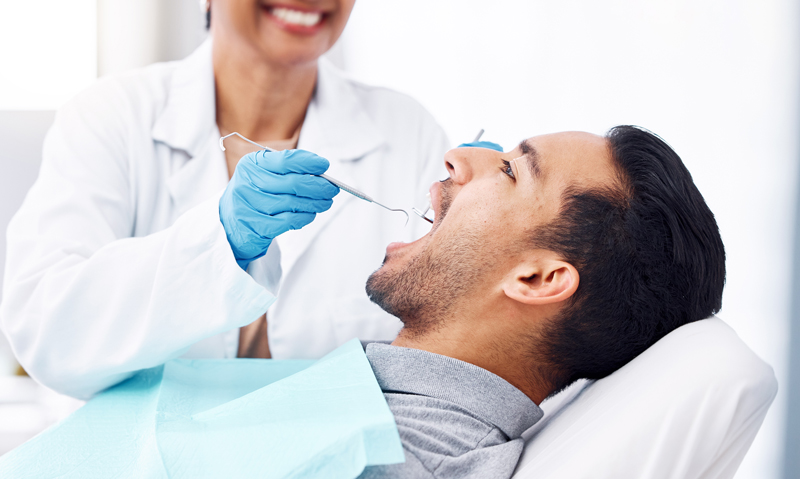 a patient getting their teeth checked out during a cosmetic procedure