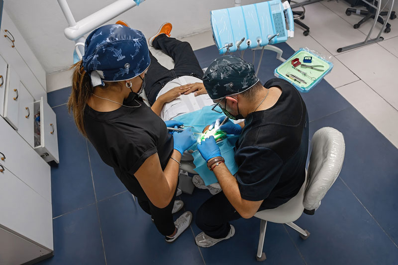 the dentist brushes teeth of patient. regular care and prevention of dental diseases. modern professional clinic