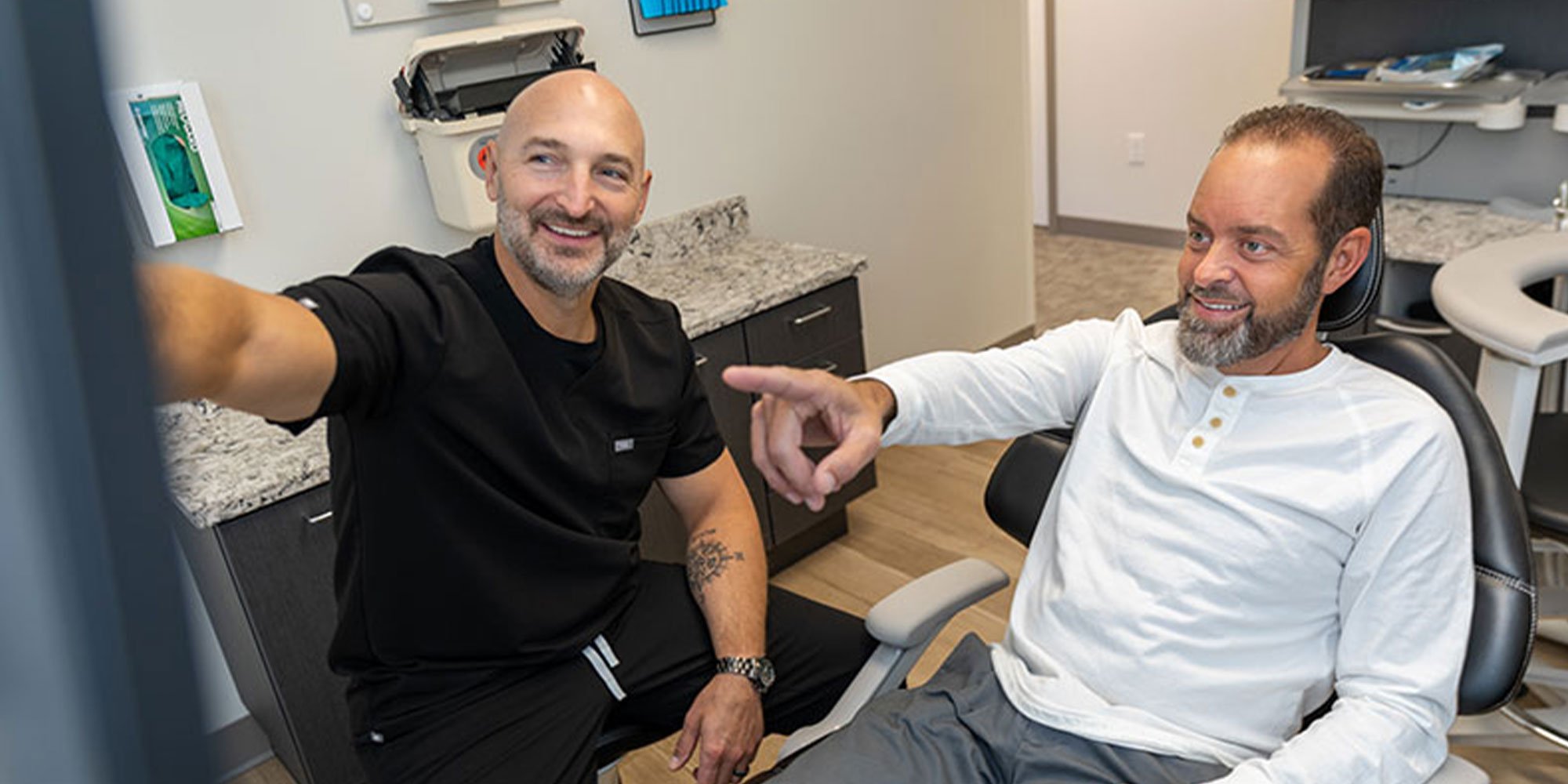 doctor and patient going over dental procedure information during treatment