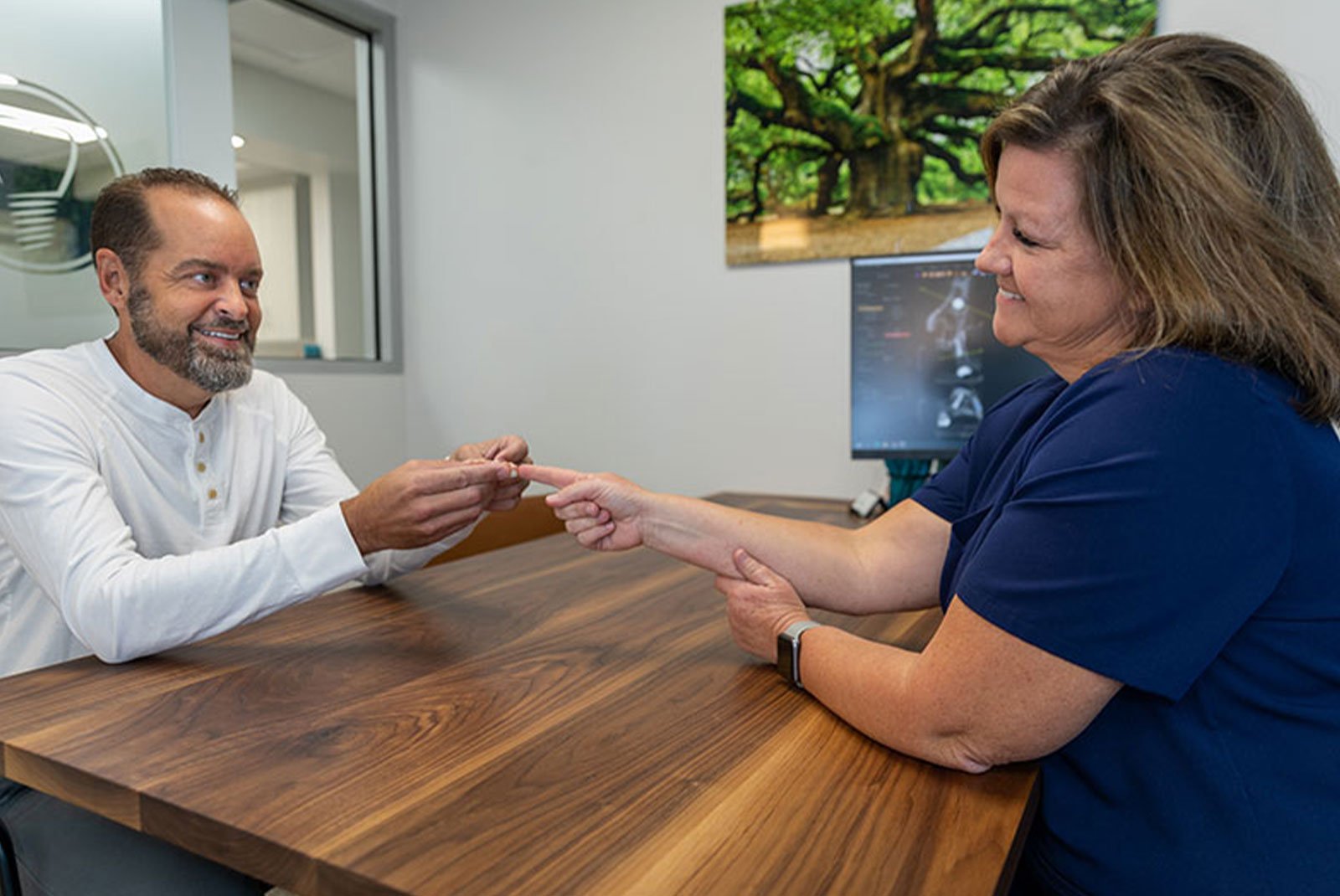 patient and staff member going over dental procedure information during consultation