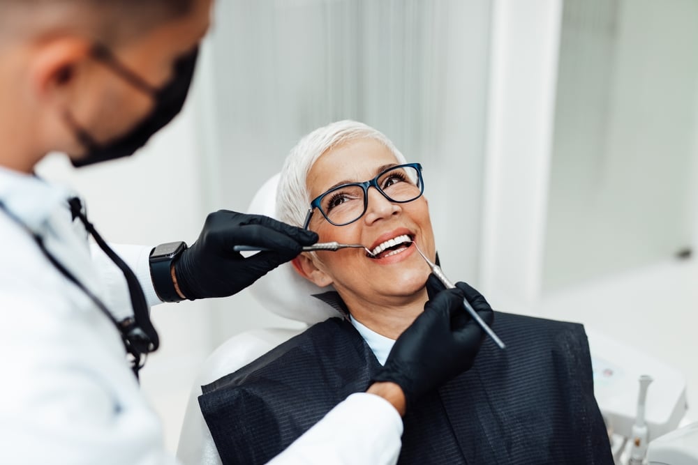 Patient and dentist discussing tooth replacement options.