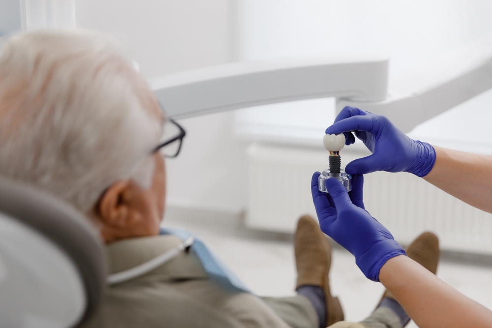Dentist explaining dental implant procedure to a patient